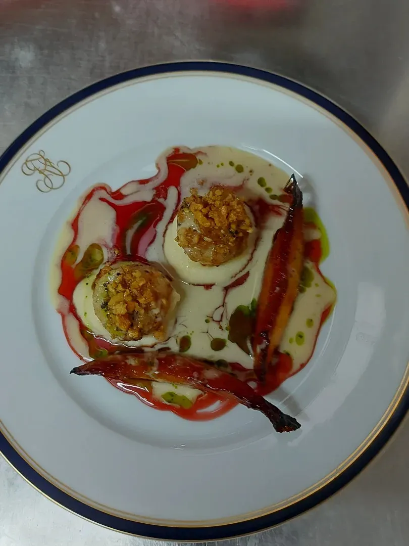 Seared scallops on a white purée with roasted carrot and a red coulis